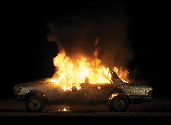 Superflex: Jakob Fenger, Bjørnstjerne Reuter Christiansen, and Rasmus Nielsen, Burning Car, 2008. Blu-ray projection.