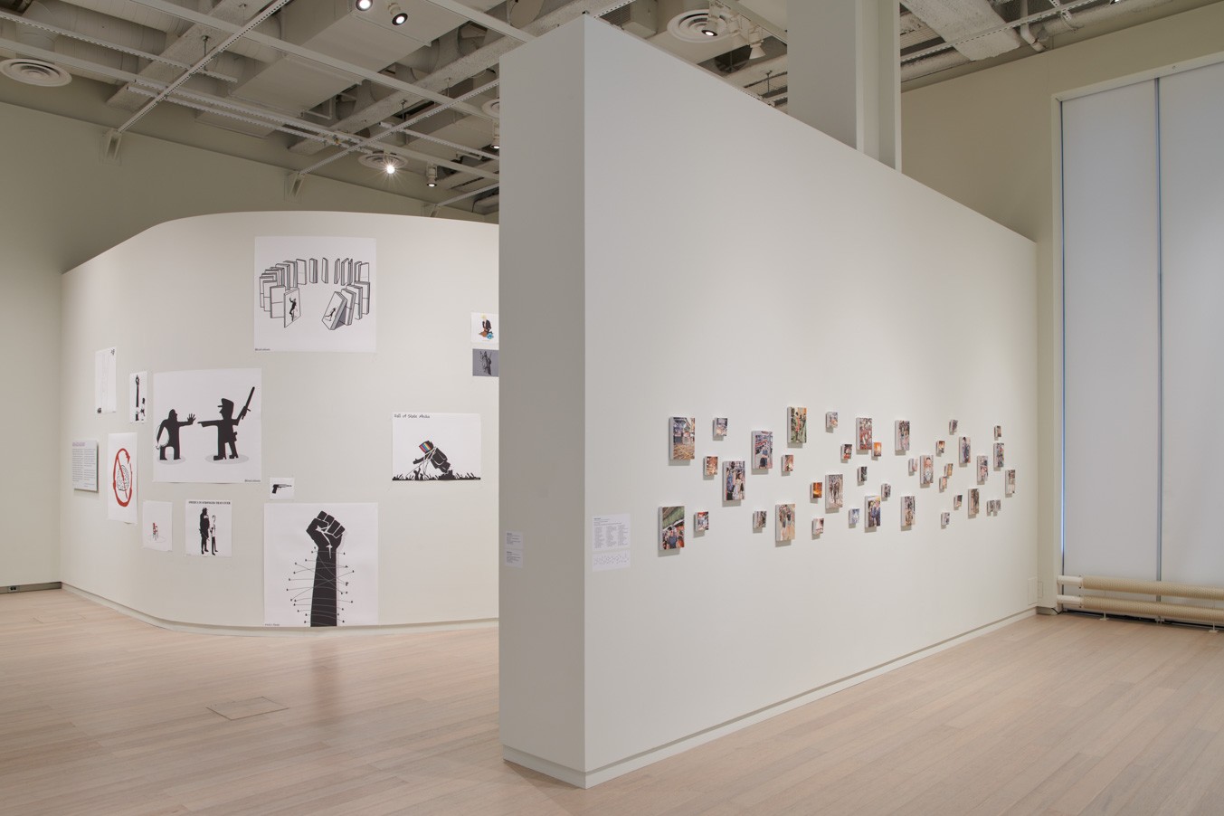 Installation view showing works by the artists Chow Chun Fai and Khalid Albaih from the exhibition “The Protest and The Recuperation” on view at the Wallach Art Gallery, Columbia University. Photograph by Kyle Knodell.