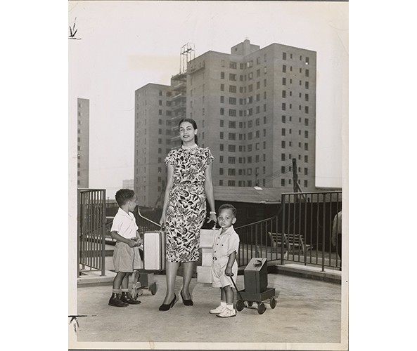 Mattie Faulkner and her children moving in, Riverton Houses, July 29, 1947, Photographs & Prints Division, Schomburg Center for Research in Black Culture, New York Public Library.