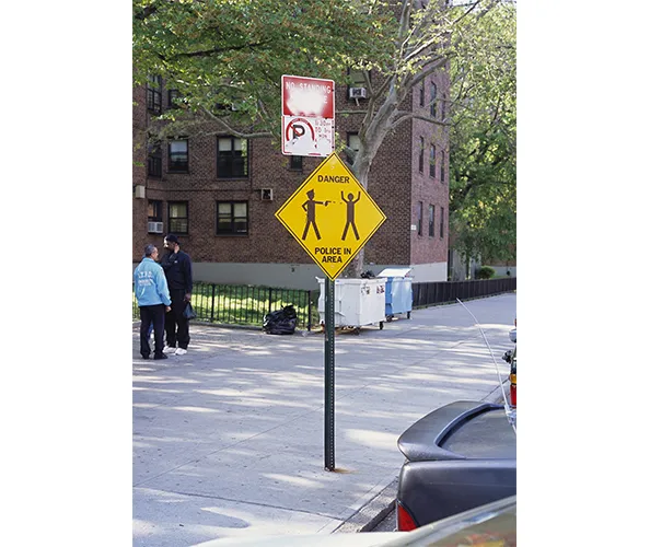 Dread Scott. Sign of the Times, 2001, installation view. Screenprint on aluminum. Courtesy the artist.