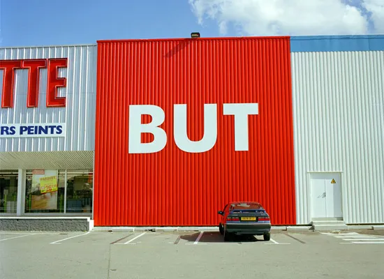 Andrea Robbins and Max Becher, BUT: American in France, Strip Malls of Toulouse, 2003. Chromogenic print.