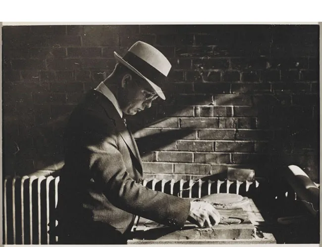 Richard Plumb carving a clay model of mounded circles c. 1940. Designs for new plots that followed the pre-World War II pattern of large circles were revised to accommodate smaller repetitive lots after the war. Avery Library, Drawings & Archives, Woodlawn Cemetery Records.